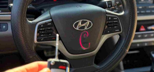 Automotive locksmith in Bedford, TX after cutting and programming a car key on-site for a local customer.